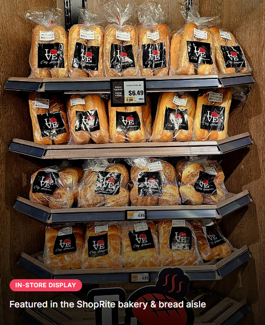 In-store display of Love City Artisan bread loaves stocked on ShopRite bakery shelves